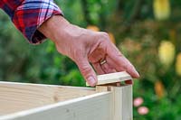 Placing a finial onto the ends of a wooden planter