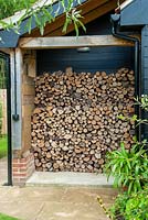 Firewood neatly stored under cover - Open Gardens Day, Great Finborough, Suffolk