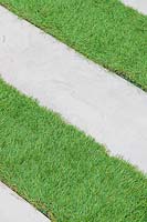 Detail of Stepping stone path across artificial lawn