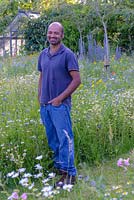 Guru Sharma in the wild flower meadow garden he helped to create. 