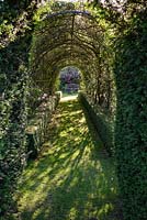 View through rose tunnel to bench in The Secret Garden, 

