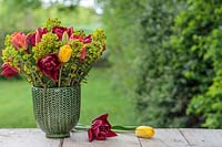 Spring arrangement in green glazed pot with Euphorbia martinii and mixed Tulips