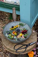 Dead cut flowers in a metal pan