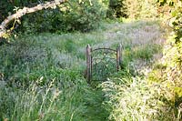 Decorative gate into wildflower meadow - Dyffryn Fernant, Wales