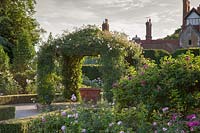 Formal Rose Garden with central arbour and Rosa 'Alberic Barbier'  Loseley Park, Surrey