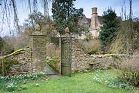 Gate with pineapple finials atop the gate posts, between the main garden and the Cherry Orchard at Rodmarton Manor, Glos, UK. 