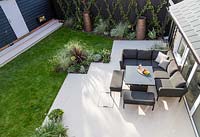 View from above of patio area with lounge furniture including a rising table. 