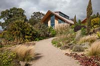 The Dry Garden at RHS Hyde Hall, showing the new educational centre building
