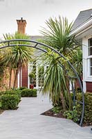 Circular metal arch framing an irregular walkway