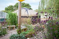 Verbena bonariensis and persicaria and gaura with yurt beyond - Sedlescombe Primary School, Sussex
