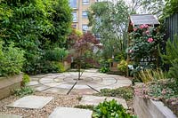 Circular paving with centrally planted Acer - Maple - in an urban garden 