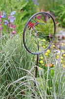 Miscanthus sinensis 'Morning Light' and metal ornament