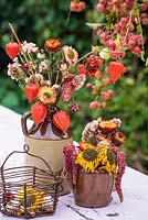 Chinese lanterns and everlasting flowers arranged in pottery bottle