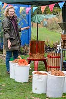 An apple press and buckets showing the pressed mash after the juice has been extracted.