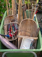 Wheelbarrow ready to garden. Trug, canes, tools, labels, kneeling pad, string.