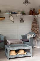 Summerhouse interior with blue painted Lloyd Loom Lansdown chairs