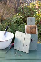 Bird Box on table with lid removed ready for cleaning with disinfectant and water in Winter ready for nesting birds in Spring