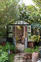 Recycled stained glass victorian doors and windows on vintage style potting shed
