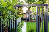 View through the pergola arch to the playhouse.