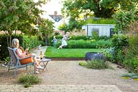 A family relaxing and playing in a contemporary city garden.