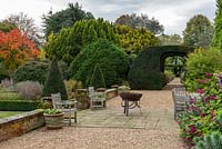 The terrace with views through a monumental yew arch to twin borders
