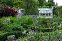 A parterre with box edged beds planted with Roses, Alliums, Lychnis, Phloxes, Toadflaxes and Mallows