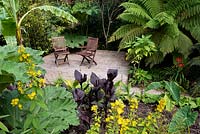 Decked area with seating in an exotic garden