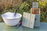 Bird Box on table with lid removed ready for cleaning with disinfectant and water in Winter ready for nesting birds in Spring