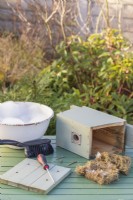 Bird box on table with this years old bedding removed ready for cleaning in Winter to make ready for Spring nesting birds