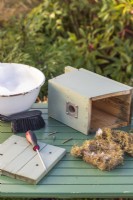 Bird box on table with this years old bedding removed ready for cleaning in Winter to make ready for Spring nesting birds