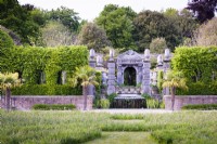 The Collector Earl's Garden at Arundel Castle, West Sussex in May. Designed by Isabel and Julian Bannermann. Hornbeam clad tunnels and pavilions frame green oak pillars and a grotto.
