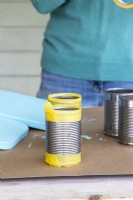 Tin cans with masking tape on the top and bottom