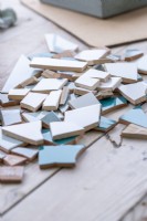 Smashed tiles laid across a wooden surface