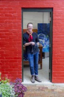 Artist in doorway of his studio