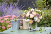 Arrangement of Callistephus 'Duchesse Apricot', Daucus carota 'Dara', Amberboa moschata 'The Bride', Nicotiana langsdorfii 'Bronze Queen', Cosmos 'Fizzy White', Nigella seed pods in a glass vase