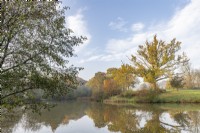 View of a lake in a country garden in autumn - November