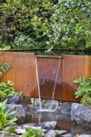 Rusty waterfall feature. The Yeo Valley Organic Garden, RHS Chelsea Flower Show 2021 Design: Tom Massey