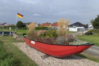 Garden feature - boat adorned with grasses and sedums. Ibersheim - Germany. 