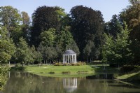 Strasbourg France Public Park l'Orangerie. 
Pond feature with buildings reflected in the waters. 