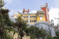 View of the Palace from the entrance with trees in foreground.  Parque da Pena, Sintra, near Lisbon, Portugal, September.
