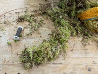 Moss bundles attached with wire to Christmas wreath ring