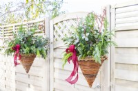 Evergreen Christmas hanging baskets either side of gate