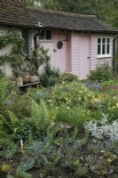 Pink outbuildings at Mill Street Gardens - May