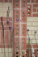 'The Marshalls Garden' at BBC Gardener's World Live 2021 - insect hotels built into decorative brick wall 