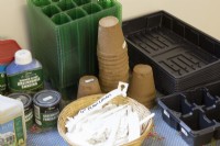 A variety of gardening sundries including seed trays, compostable plant pots, labels and greenhouse shading paint and fumigator. 