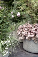 Trio of ribbed ceramic planters with pastel mix foliage and flowers