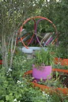 Urban community garden with bright, colourful landscaping and container planting