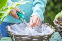 Woman cutting a hole in the lining for drainage