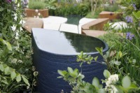 View of the drop-shaped water feature in the BBC Studios Our Green Planet and RHS Bee Garden - Designer: 