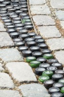 Pavement with recycled material like bottles.